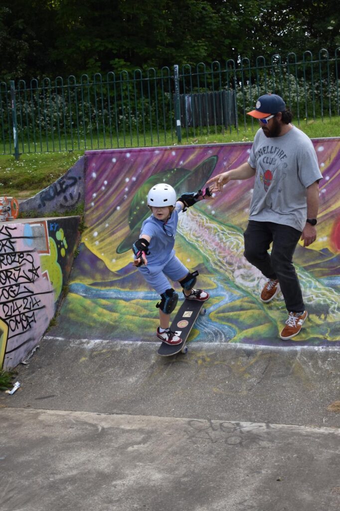 Rick is helping Annie overcome her fear of dropping in big ramps by holding her hand for some assurance. After this attempt she was fully able to do this by herself